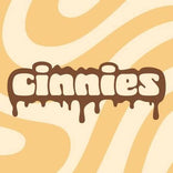 The word Cinnies in brown, rounded, melting-style lettering against a beige and cream wavy background.