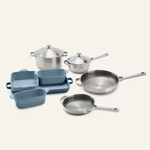 Titanium Pro Cookware + Bakeware Set 2.0 featuring high-performance stainless steel cookware, including two lidded pots and two skillets, alongside a set of blue ceramic bakeware.