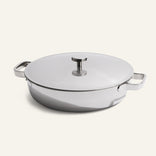 Titanium Braiser Pro, an oval-shaped, chef-approved braiser pan made from stainless steel with two side handles and a flat lid, displayed on a light background.