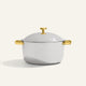 A silver-colored Titanium Perfect Pot Pro 7 qt. lidded pot with gold-toned side handles and a gold-toned lid knob.